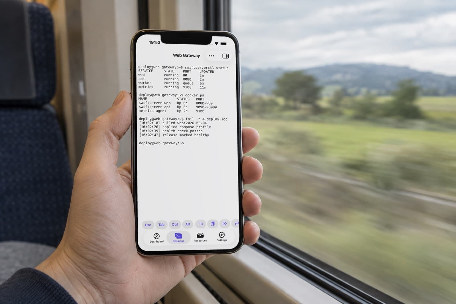 A Mosh session on an iPhone, held by a train window
